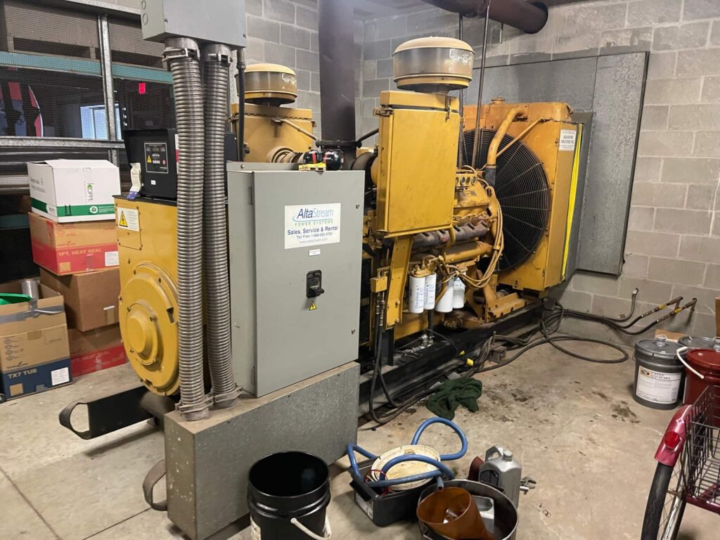Stationary standby generator set in a mechanical room during maintenance